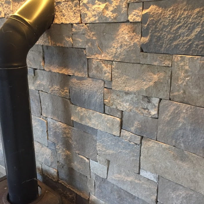 Close up of fireplace feature wall in Blue Centre Sandstone Stoneer Cladding.