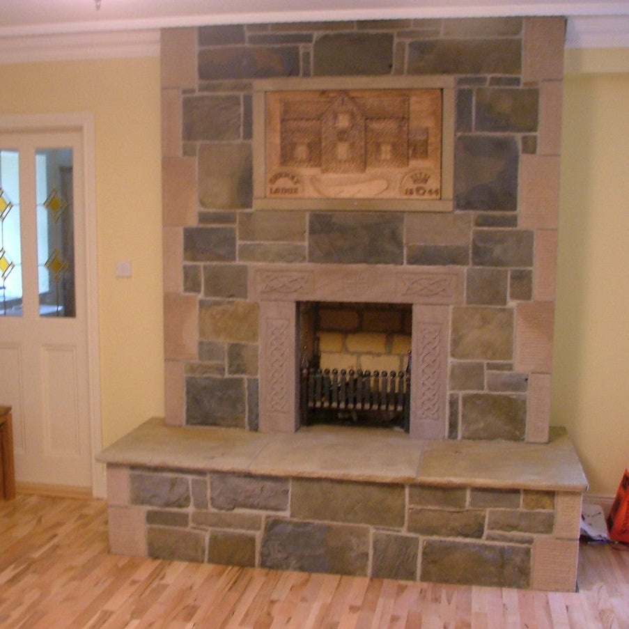 Internal stone fireplace completed using Blue Grey Sandstone Machined and Architectural sandstone surround   and Quoins with celtic engravings. 