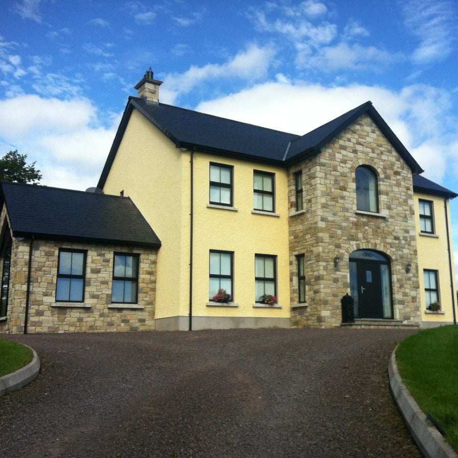 Two storey house with stone feature walls completed in Blue Grey Sandstone Machined. 