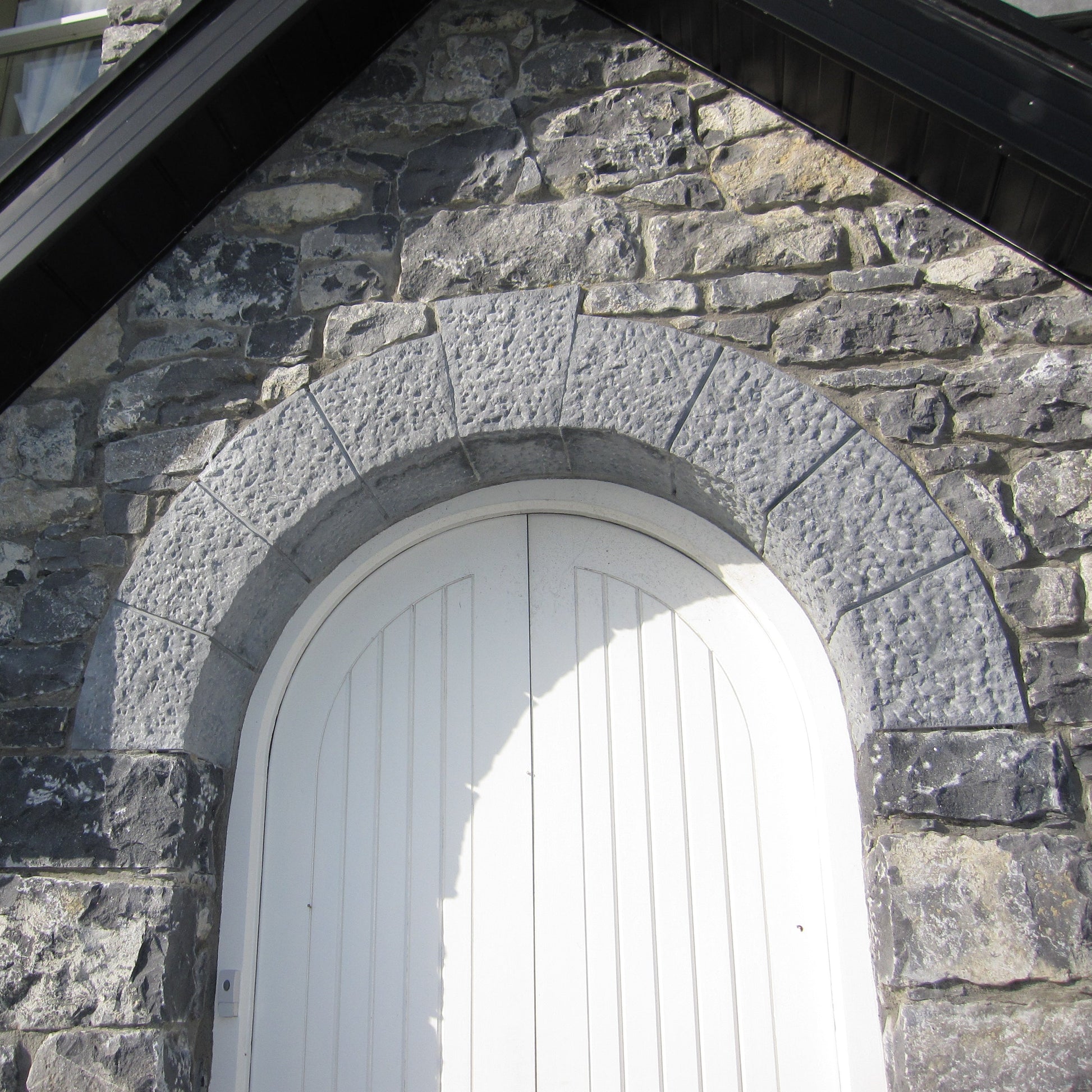 Bespoke Blue Limestone Door Lintel with a white door on a stone porch.