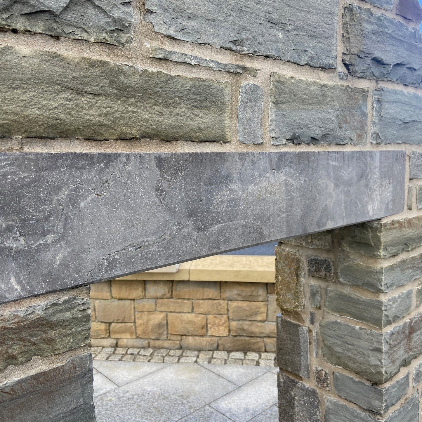 Close-up of a stone wall with blue limestone lintel. 