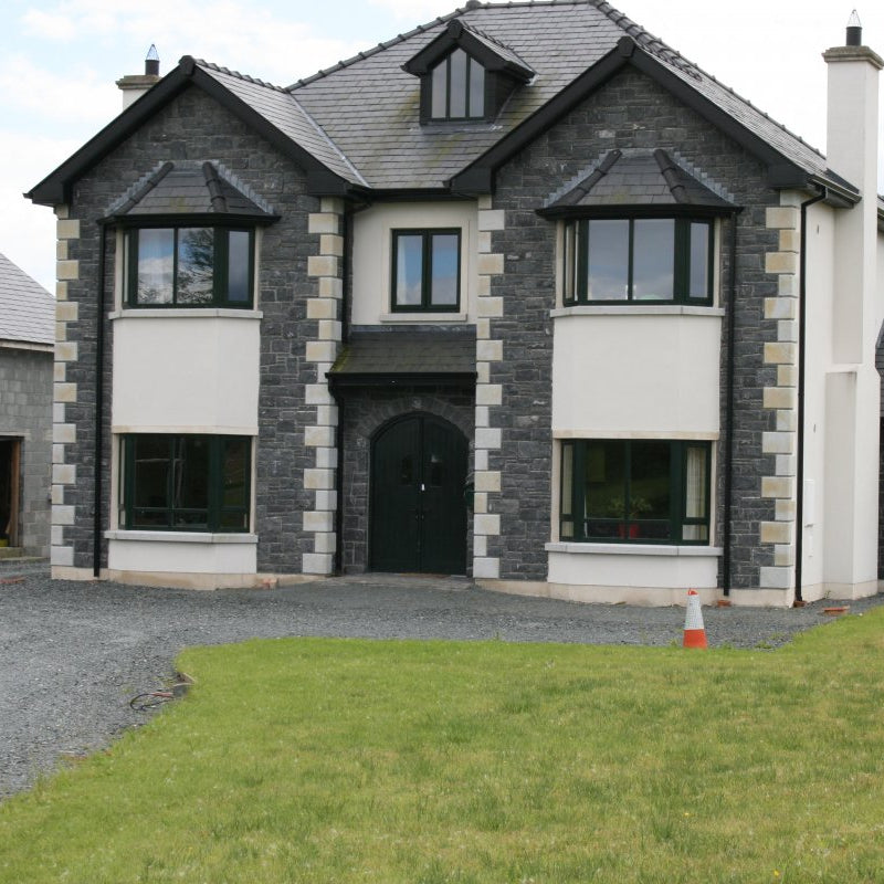 Two Storey house with external stone facades in blue limestone machined building stone. 
