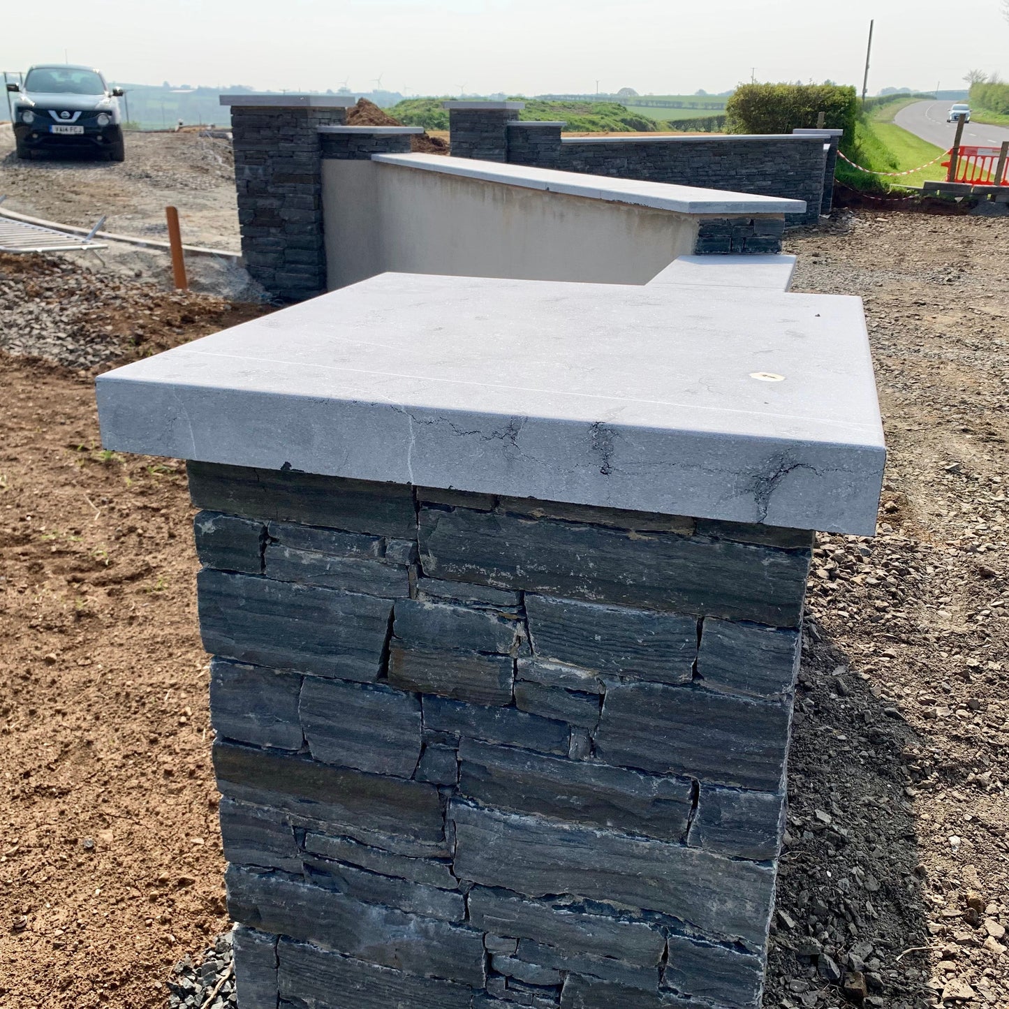 Newly built entrance walls and pillars completed in liscannor slate and bespoke flat blue limestone wall and pillar capping. 