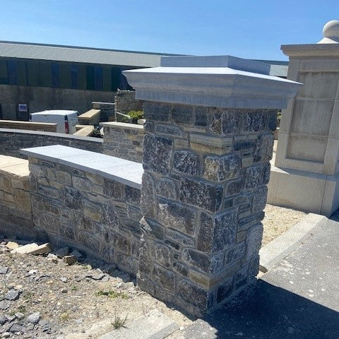Stone column with bespoke blue limestone pillar cap on display at McMonagle Stone.  