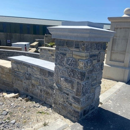 Stone column with bespoke blue limestone pillar cap on display at McMonagle Stone.  