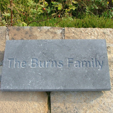 Rectangular blue limestone plaque with 'The Burns Family' engraved. 