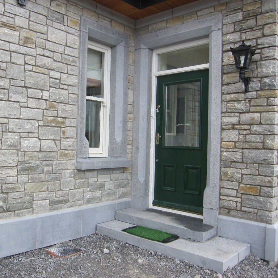 Bespoke blue limestone window and door surrounds, plinths and steps. 