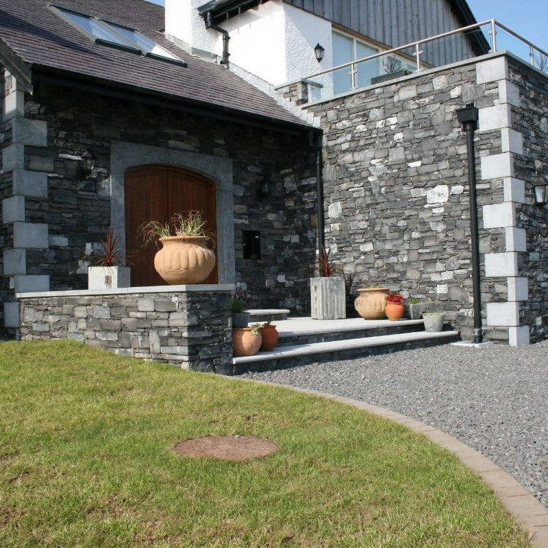 Modern house entrance featuring bespoke blue limestone quoins. 