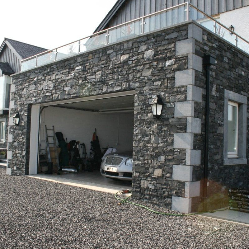 Stone garage with bespoke blue limestone quoins. 