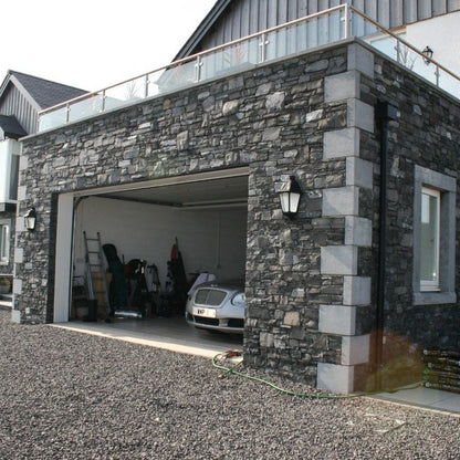 Stone garage with bespoke blue limestone quoins. 
