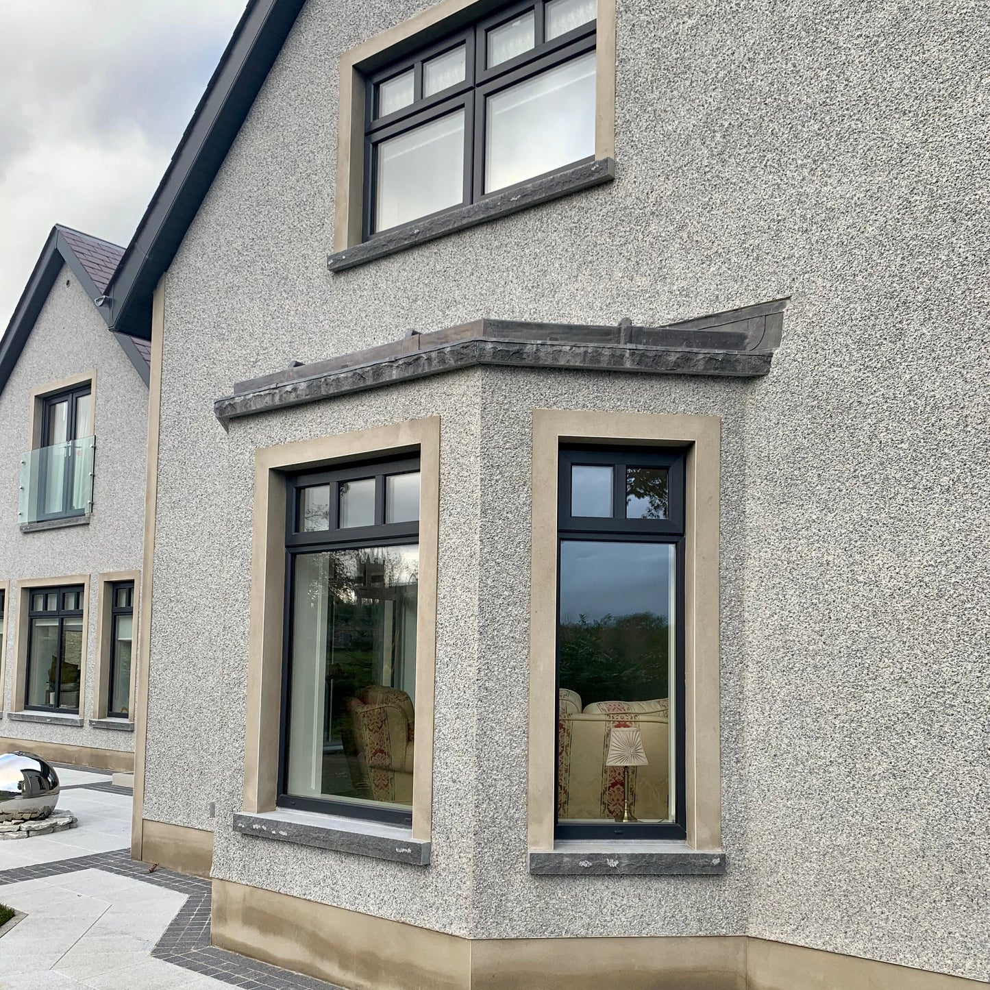 House exterior with modern windows and bespoke blue limestone sills with a rockfaced finish. 