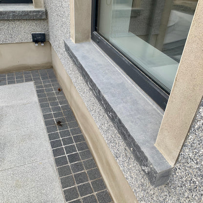 Bespoke blue limestone window sill with rockfaced edge 