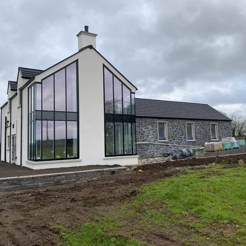 Modern new build with blue limestone façade built using stoneer cladding. 