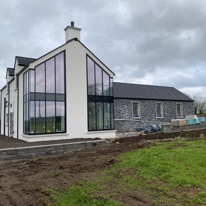 Modern new build with blue limestone façade built using stoneer cladding. 