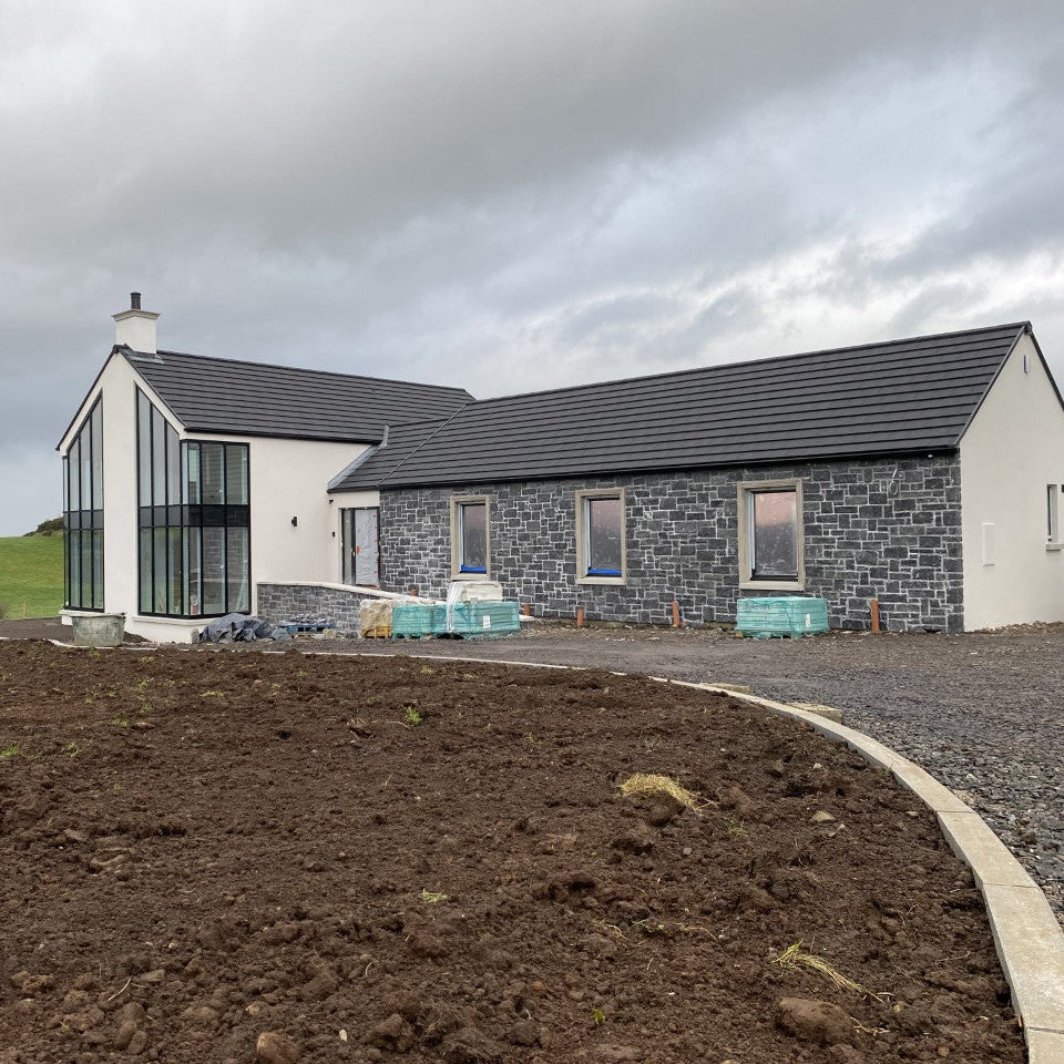 Modern new build with blue limestone façade built using stoneer cladding. 