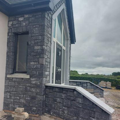New build with entrance walls cladded in Blue Limestone Stoneer Cladding.