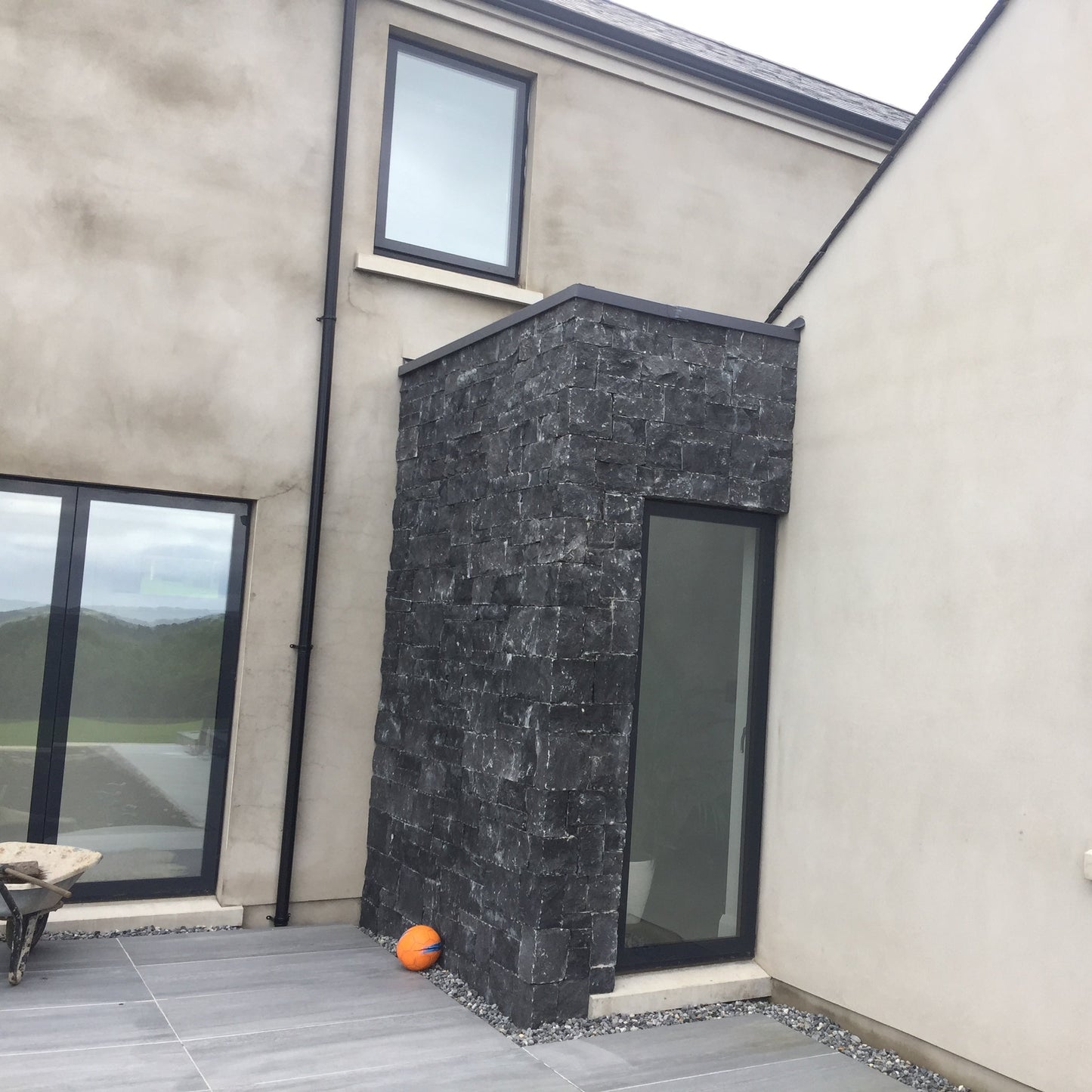New build porch cladded in blue limestone stoneer cladding.