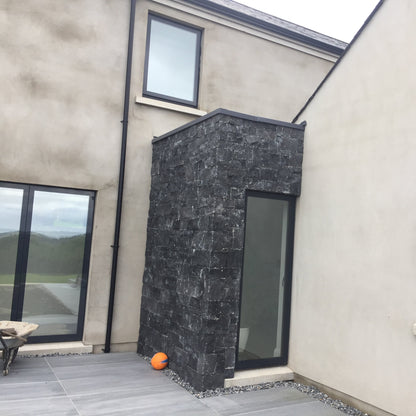 New build porch cladded in blue limestone stoneer cladding.