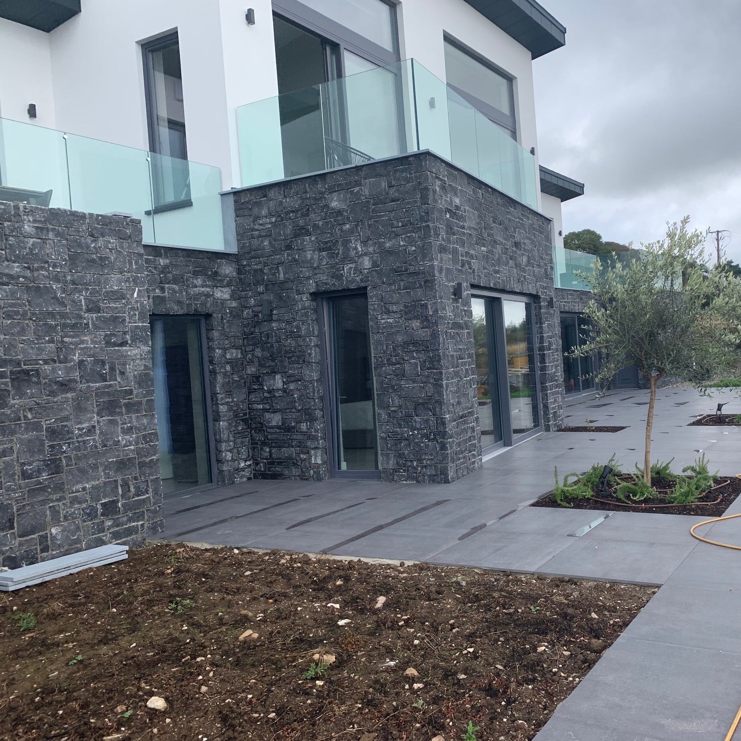Large modern two storey with ground level cladded in Blue Limestone Stoneer Cladding. 