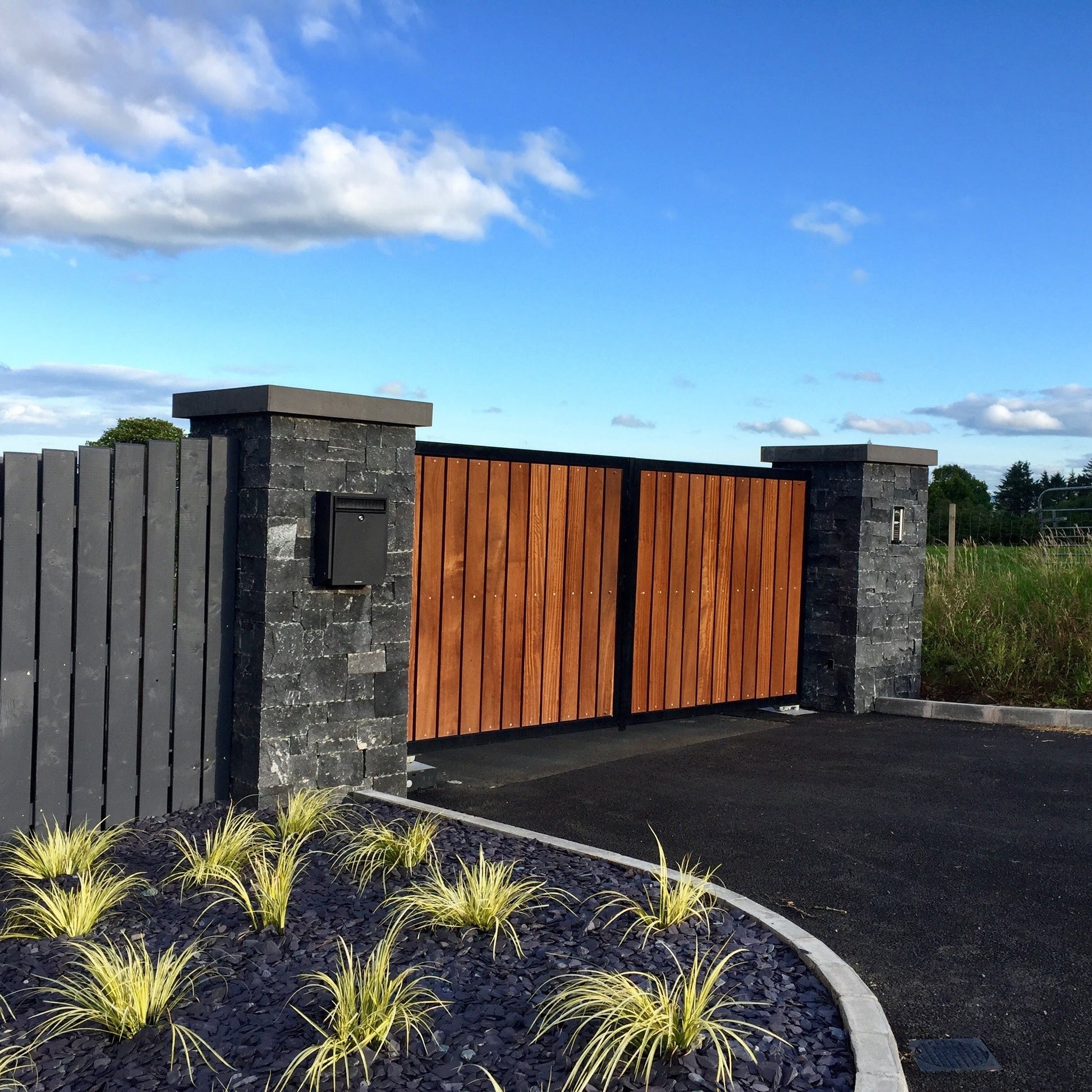 Entrance pillars completed using Blue Limestone Stoneer Cladding and bespoke Limestone pillar cap. 