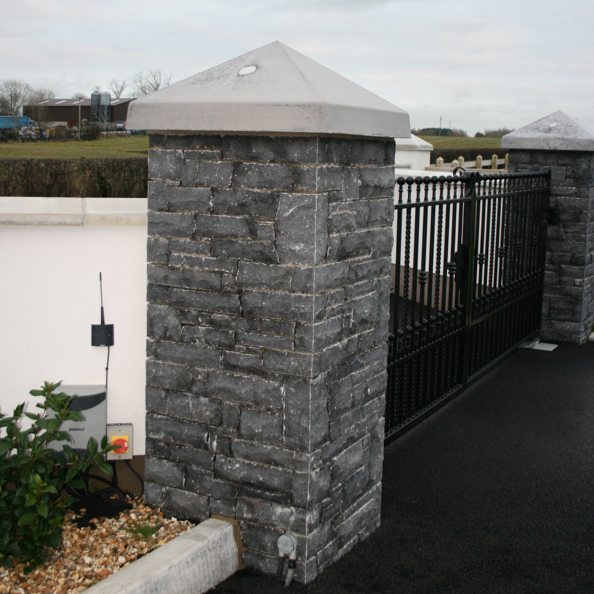 Entrance pillars completed using Blue Limestone Stoneer Cladding and bespoke Limestone pillar cap. 