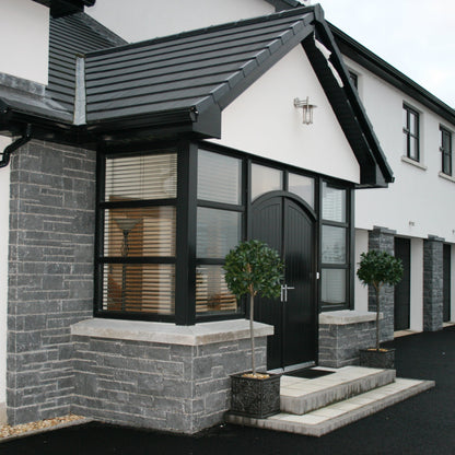 Modern new build cladded in Blue Limestone Stoneer Cladding.