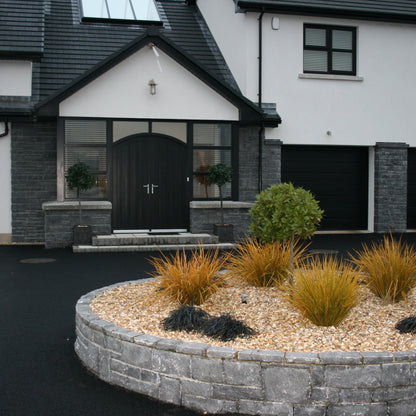Contemporary home with stone feature walls and driveway garden wall cladded in Blue Limestone Stoneer Cladding.