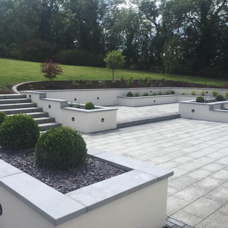 Patio walls completed with bespoke blue limestone wall capping. 