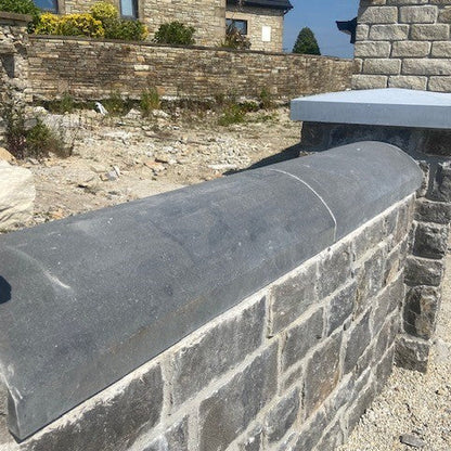 Bespoke rounded blue limestone wall capping. 