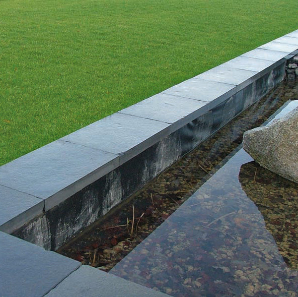 Water feature walls completed using bespoke blue limestone wall capping. 