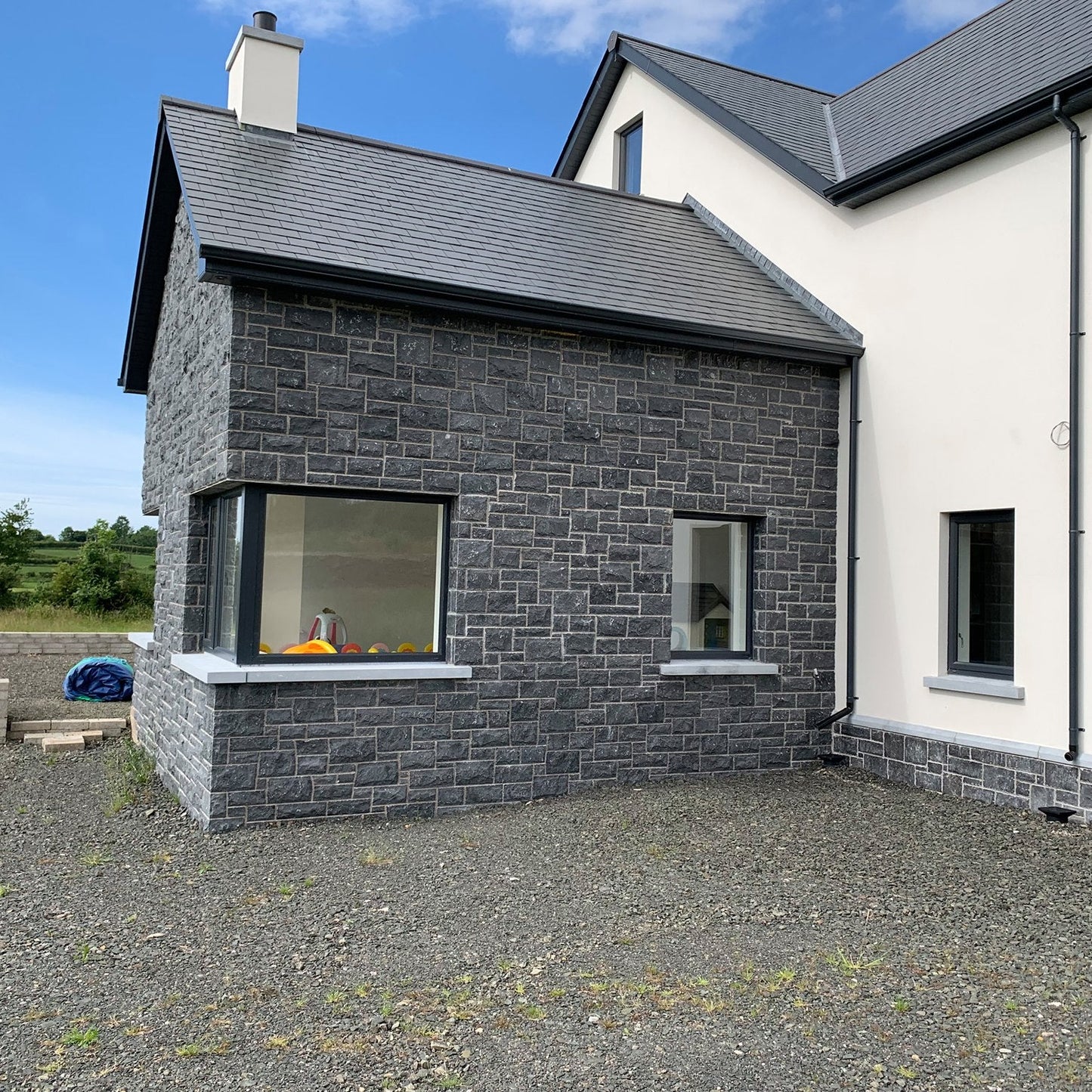 Stone sunroom with bespoke blue limestone window sills with corner splayed returned. 