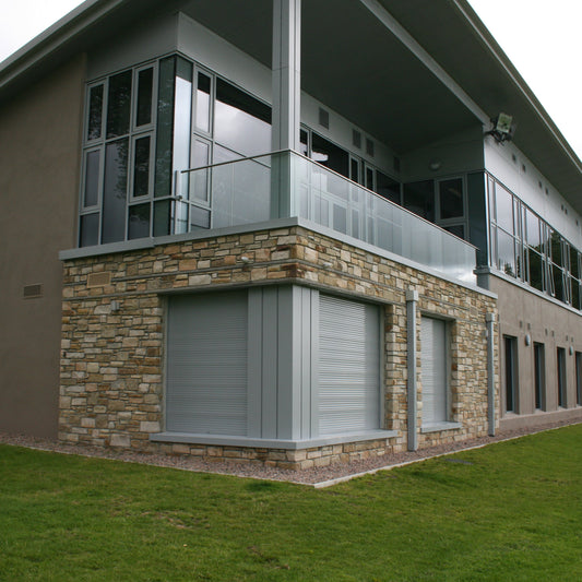 Large building with a natural stone feature wall in Caramel Sandstone machined building stone. 
