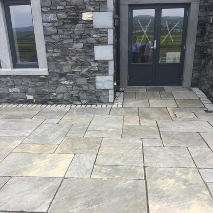 Stone house with patio area completed using Cider Black Sandstone Paving. 
