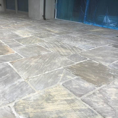 Close up of a new patio area finished using Cider Black Sandstone Paving in mixed patio pack sizes. 
