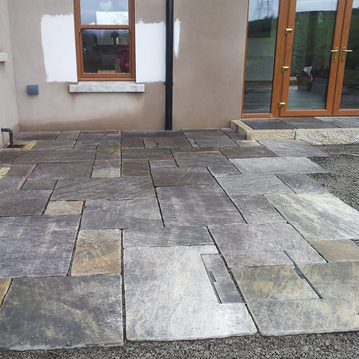 Patio under construction using Cider Black Sandstone patio packs. 