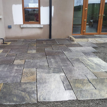 Patio under construction using Cider Black Sandstone patio packs. 