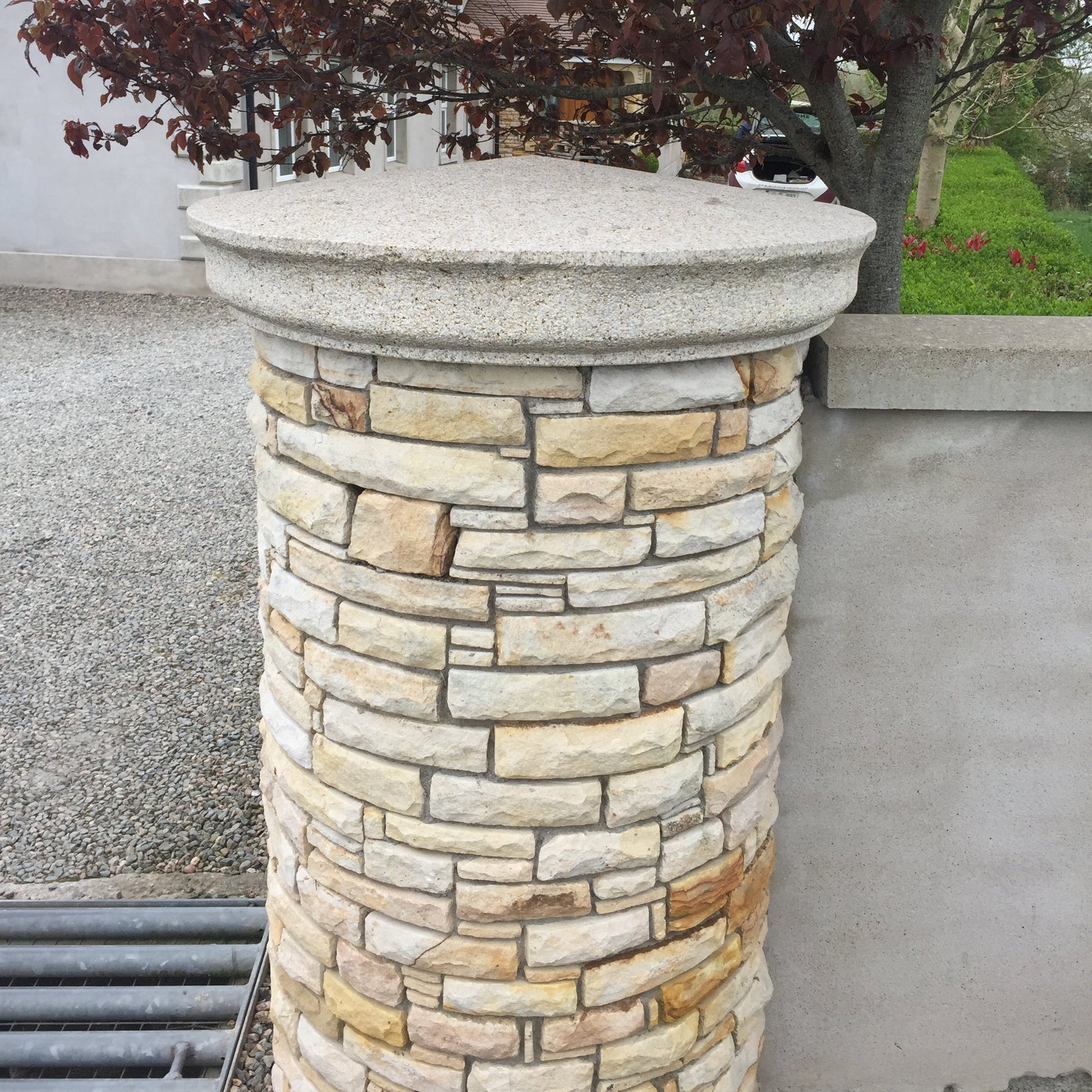 Gold Donegal Quartzite circular pillar with bespoke silver granite circular pillar cap. 
