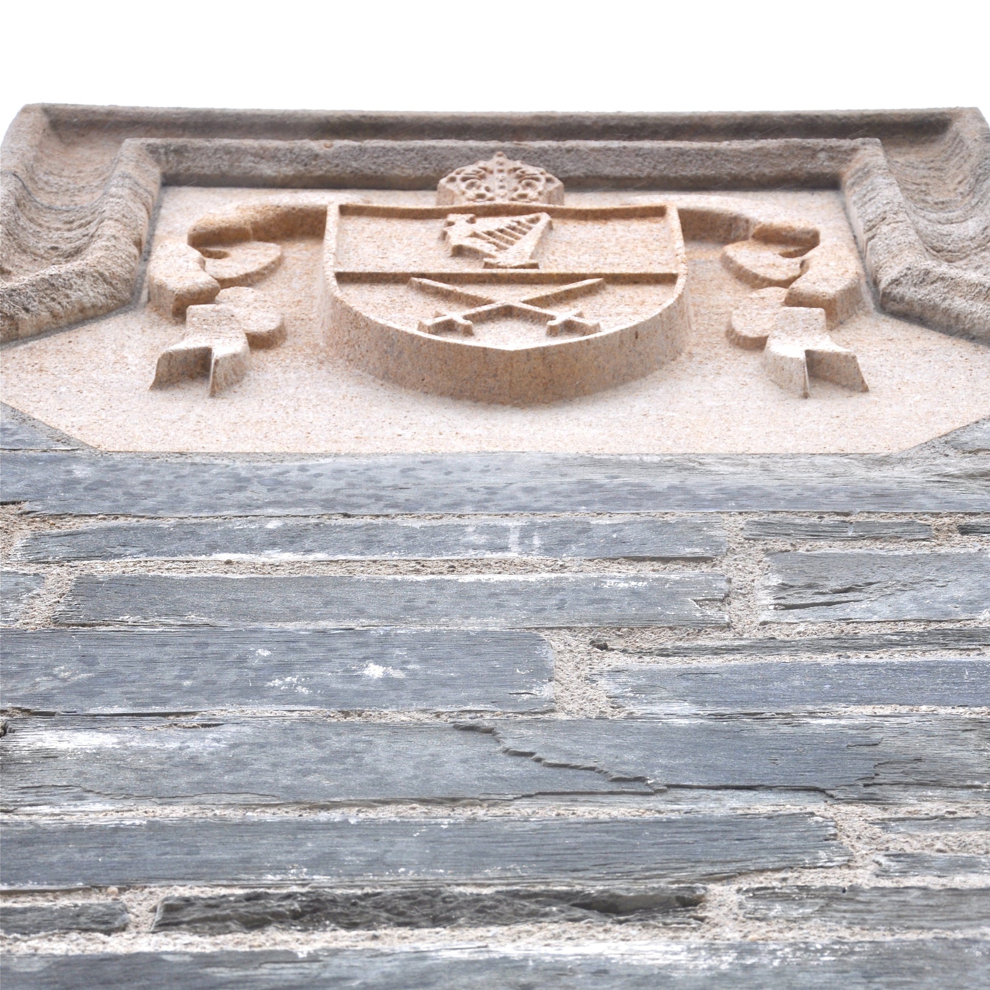 Bespoke Coat of arms in Clipsham Limestone embedded in a stone wall