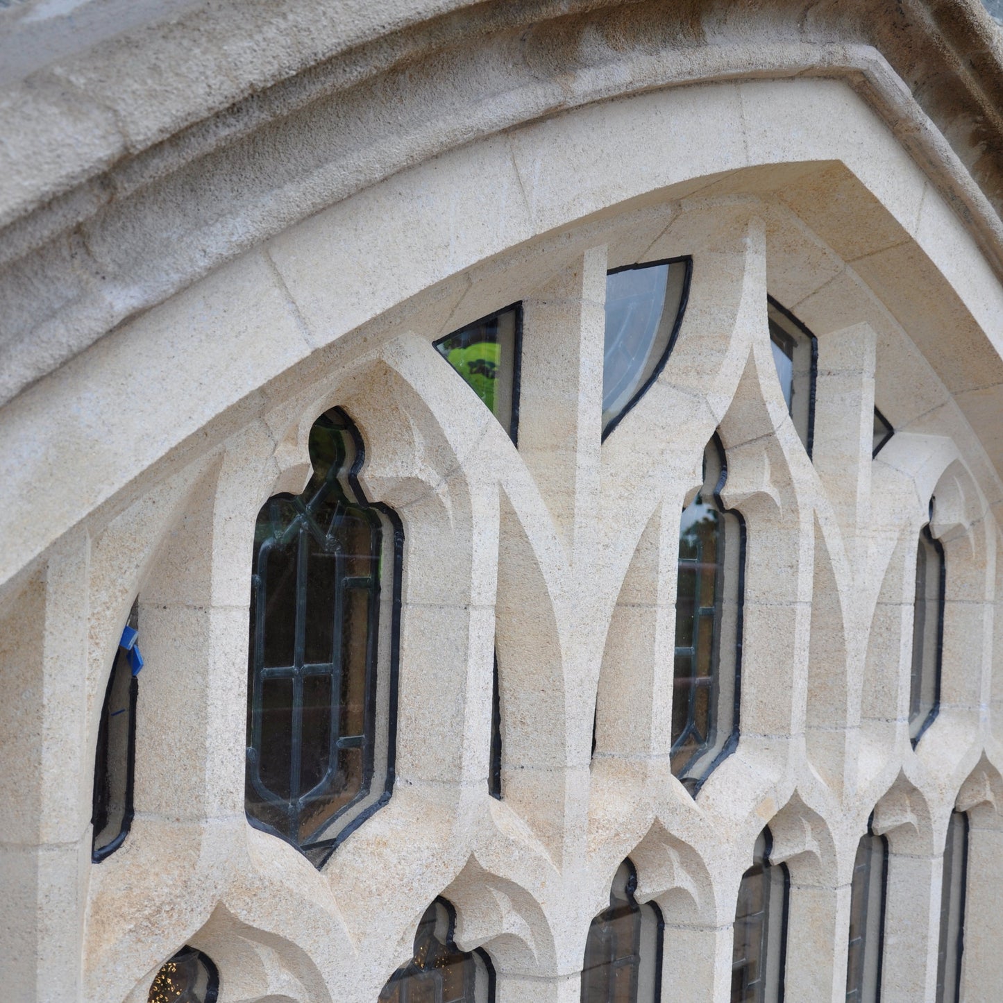 Gothic-style window with architectural limestone arches and detailed stonework