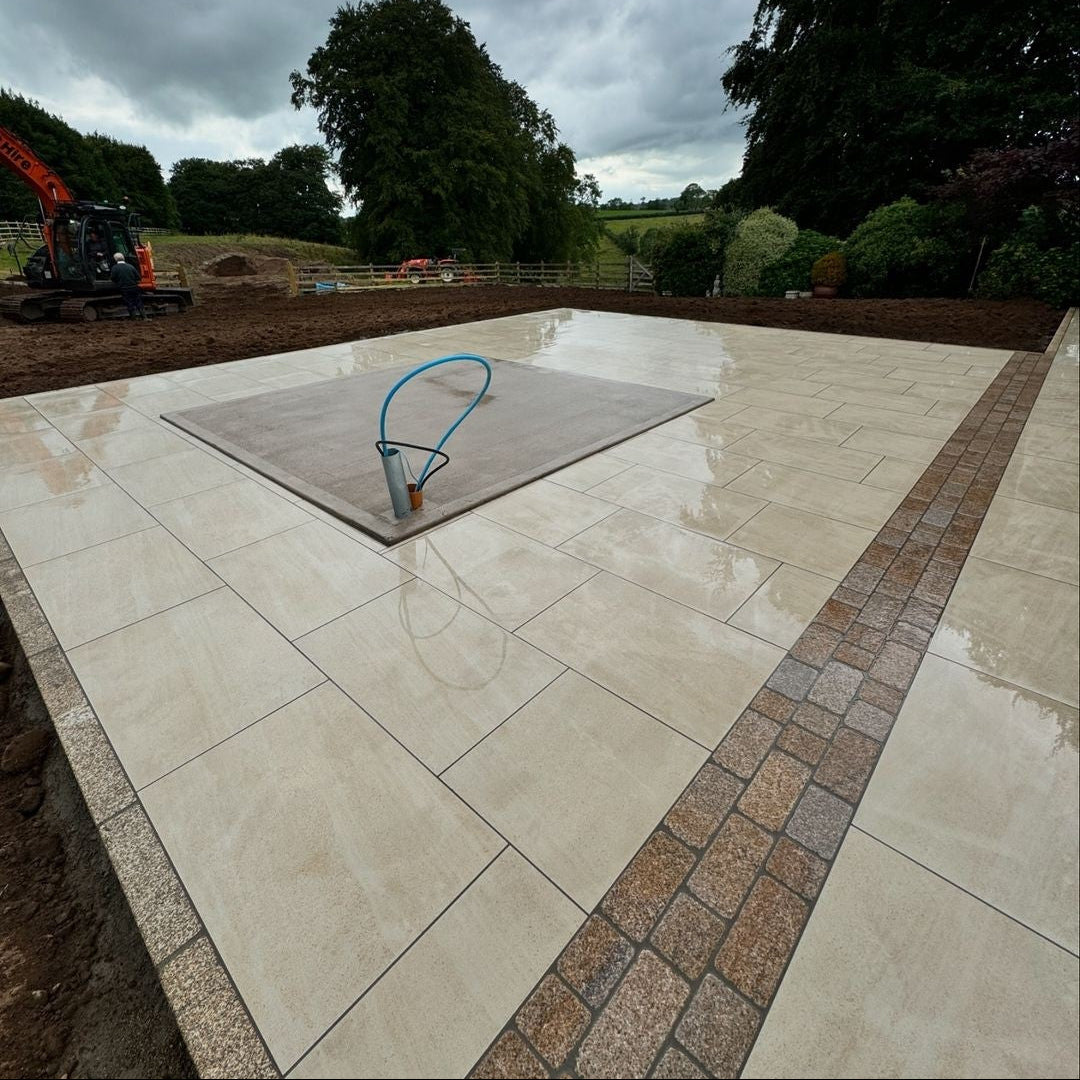 Contemporary patio area featuring Coachmans Gold Granite Paving Setts. 