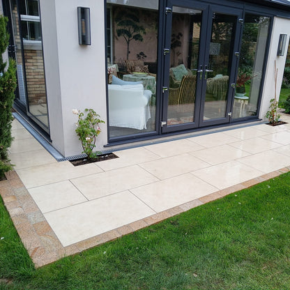 Modern newbuild with pathway border completed using Coachman's Gold Granite Paving Setts. 
