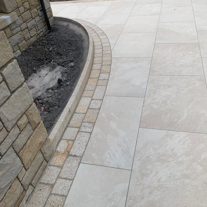 Patio edging featuring Coachman's Gold Granite Paving Setts. 