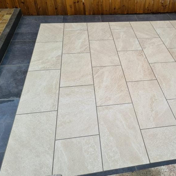 Small patio area featuring Cream Twice Qz Range Porcelain Paving Tiles. 