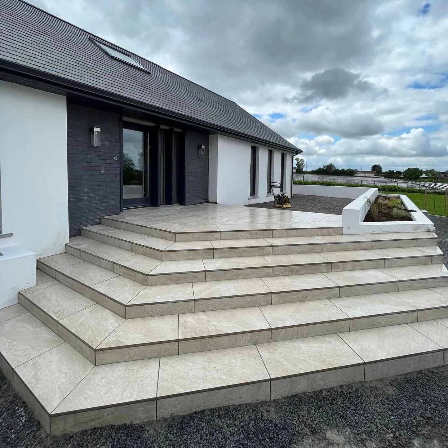 Modern step entrance completed using Cream Twice Qz Range Porcelain Paving Tiles. 