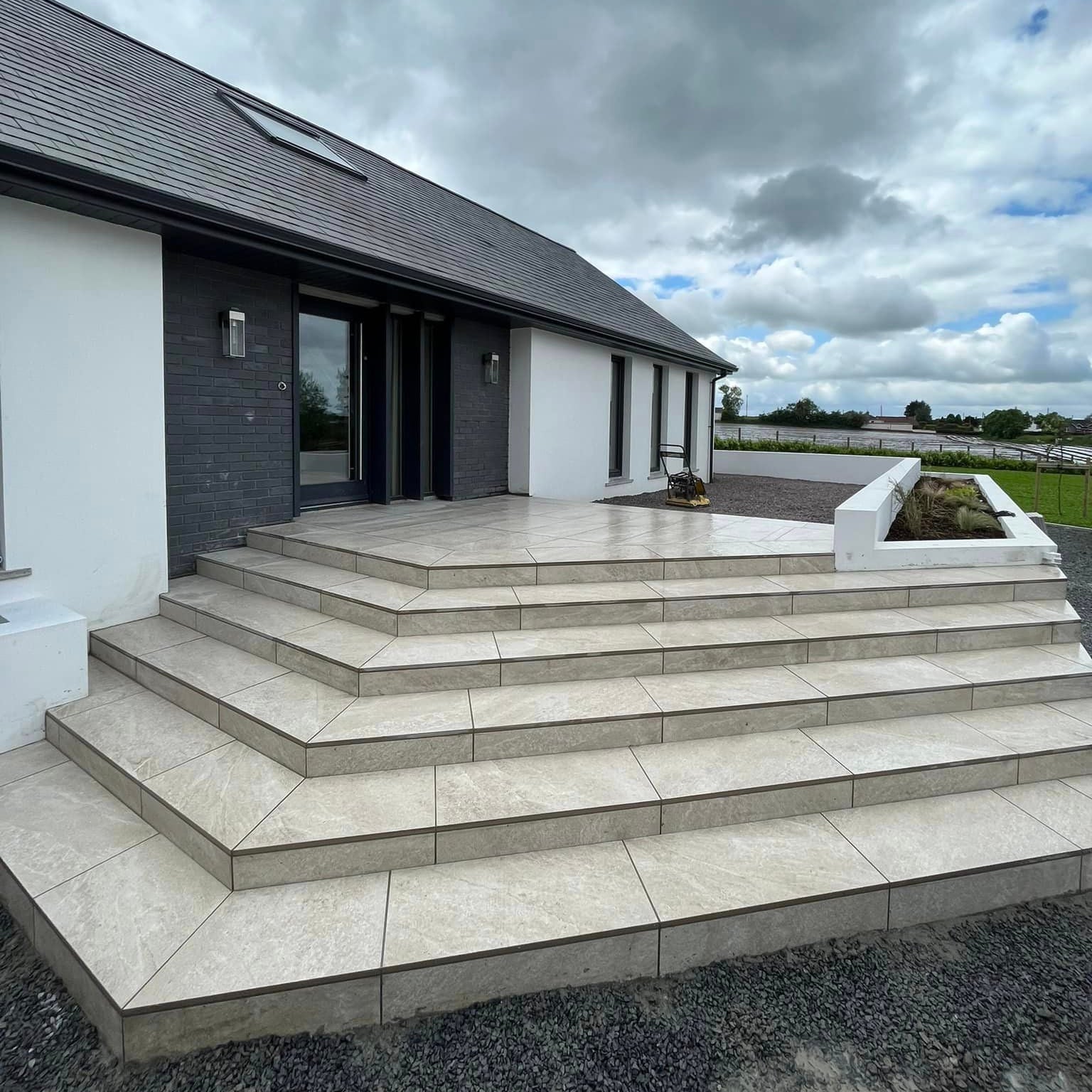 Modern step entrance completed using Cream Twice Qz Range Porcelain Paving Tiles. 