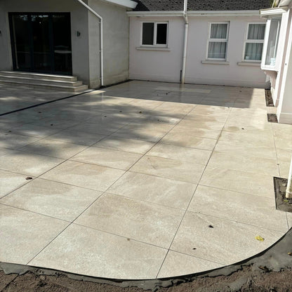 Patio area under construction using Cream Twice Qz Range Porcelain Paving Tiles. 