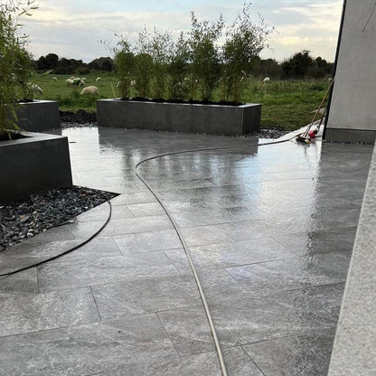 Another angle of this patio area with raised planter beds. Paving featured is Dark Twice Qz Range Porcelain Paving Tiles. 