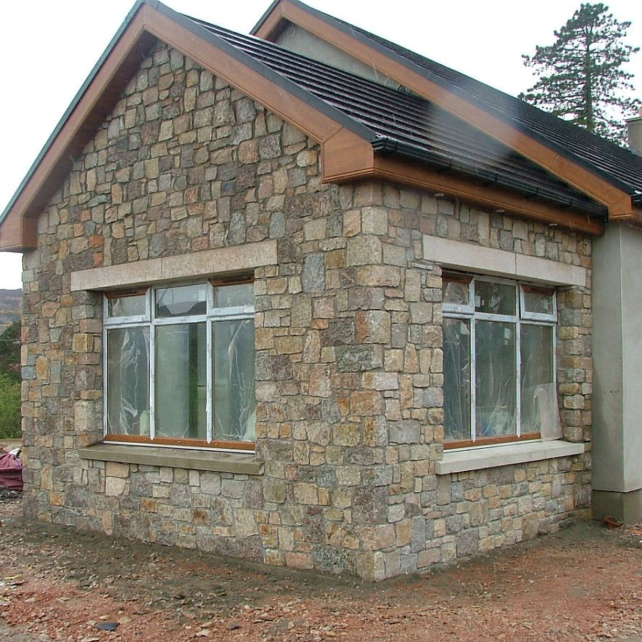 New build home with a stone façade in Donegal Granite Machined and Gold Granite Lintels. 