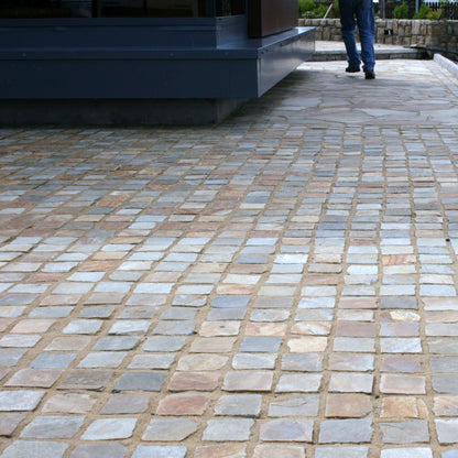 Patio area completed using Donegal Quartzite Cobbles in 100 x 100mm size and Donegal Quartzite Crazy paving in a pathway in the background. 
