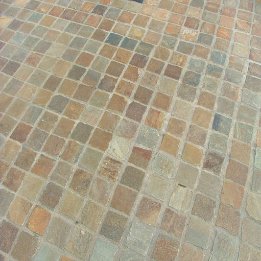 A close-up view of Donegal Quartzite Cobbles in 100 x 100mm size, showing the texture and natural colour variation between the stones.